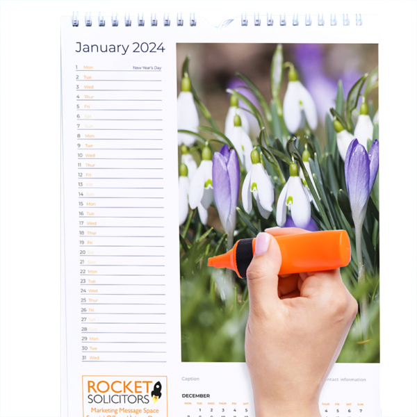 Hand with highlighter writing on calendar