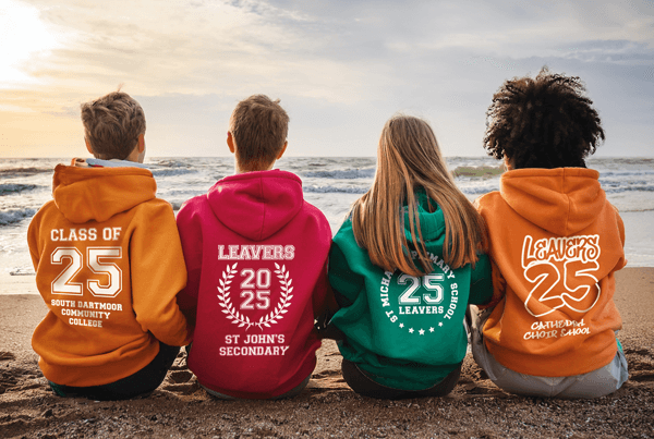 Teens on beach wearing hoodies